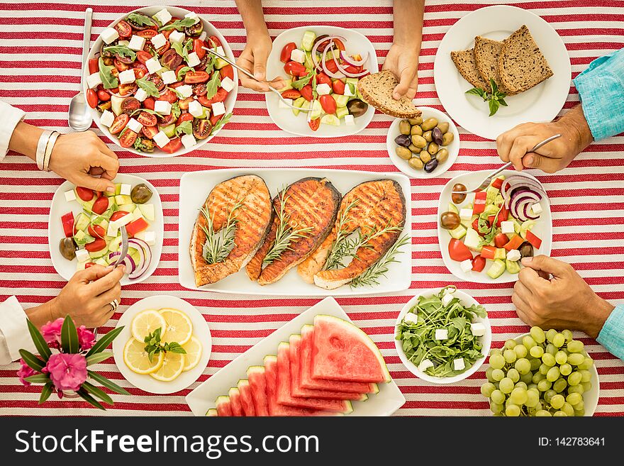 Top view of table with fish, salads, fruits and vegetables. Mediterranean diet. Healthy food concept. Top view of table with fish, salads, fruits and vegetables. Mediterranean diet. Healthy food concept