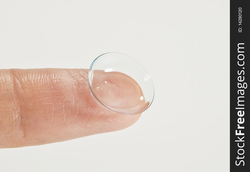 Contact lens on finger close-up