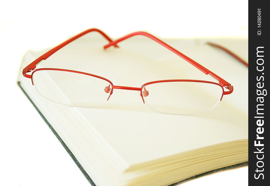 Notebook Made Of A Red Skin And Glasses