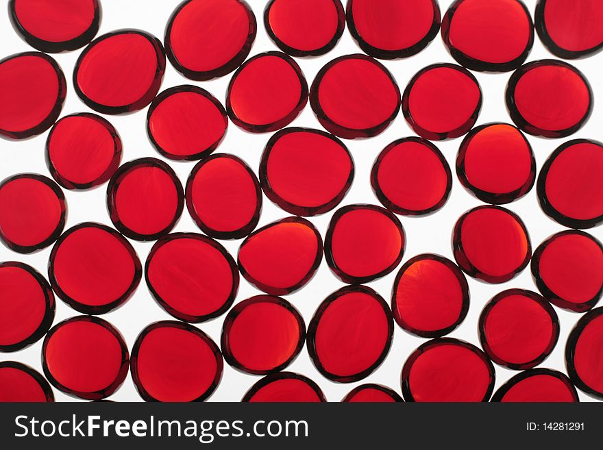 Red fragments of glass on a white background. Red fragments of glass on a white background