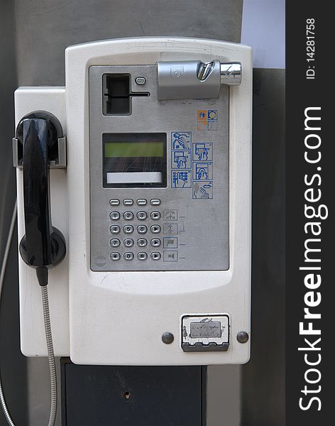 Coin and credit card operated public phone