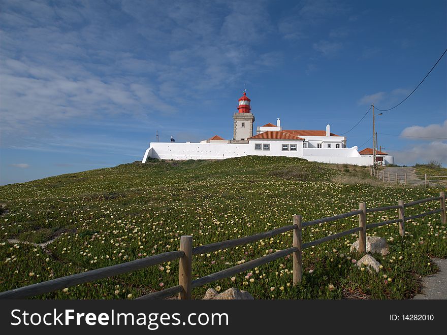 Lighthouse and adjacent buildings on a hill top