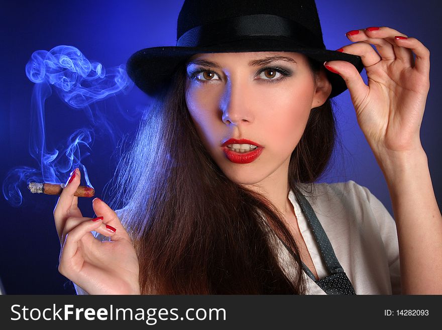 Beautiful young woman smoking cigar. Beautiful young woman smoking cigar