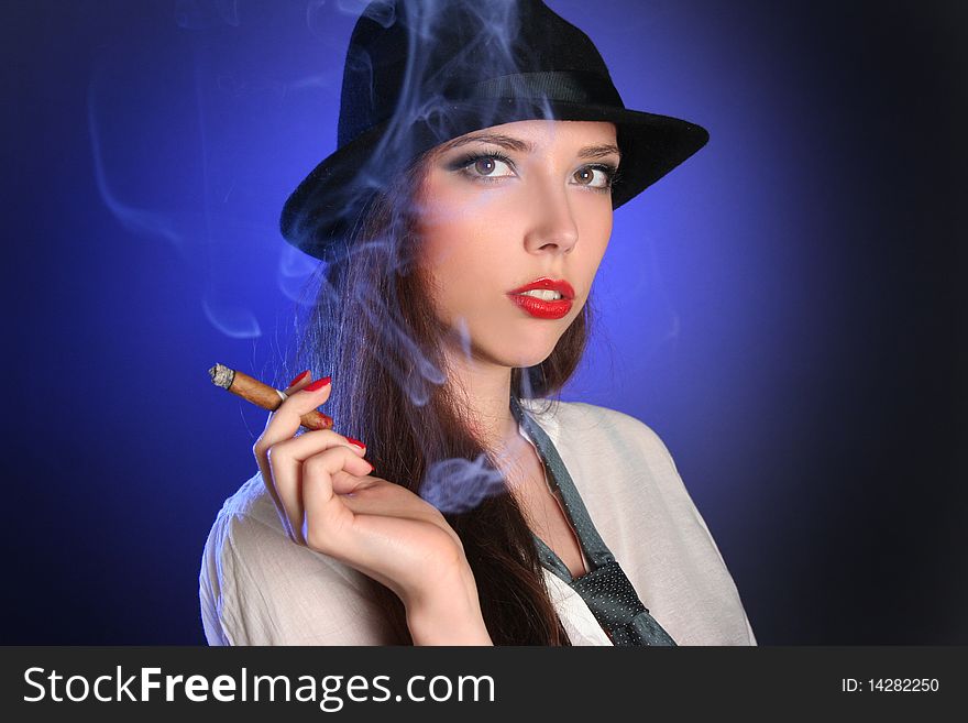 Beautiful young woman smoking cigar. Beautiful young woman smoking cigar