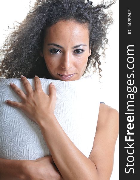 Portrait of beautiful woman with curly hairs holding pillow. Portrait of beautiful woman with curly hairs holding pillow