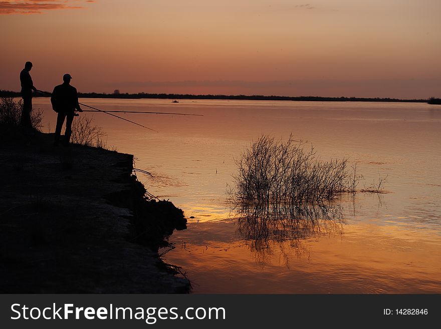 Silhouette of Fishermen on a sunset