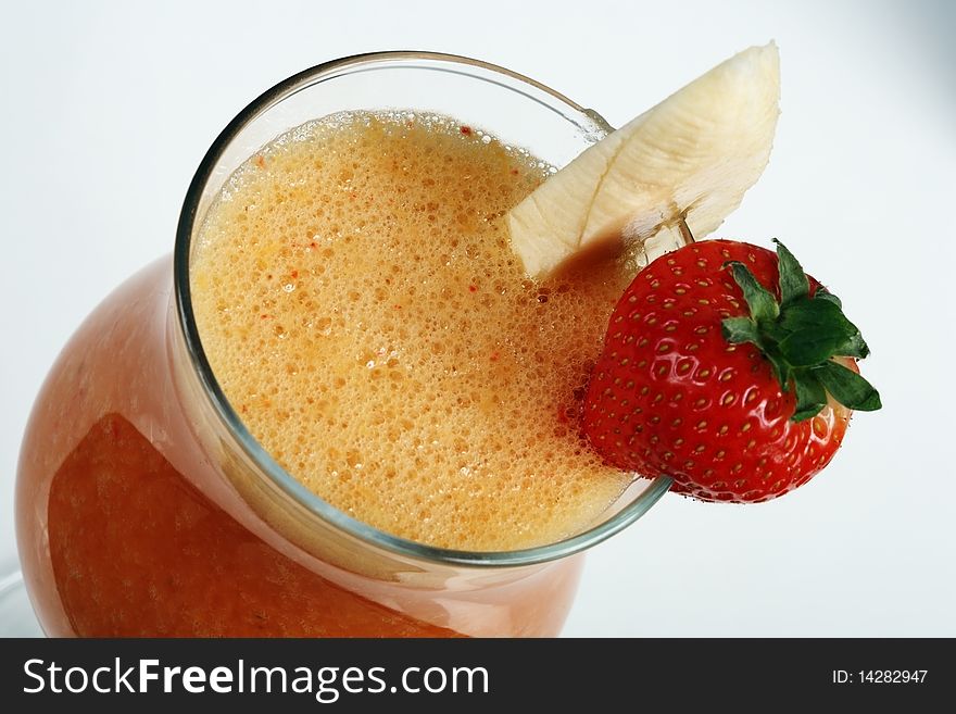 Banana and strawberry smoothies. Close-up on a grey background. Banana and strawberry smoothies. Close-up on a grey background.