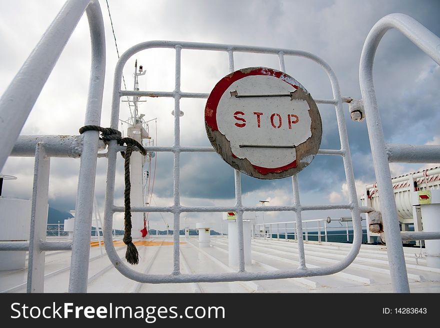 Sign Stop on a gate on boat, ferry trip