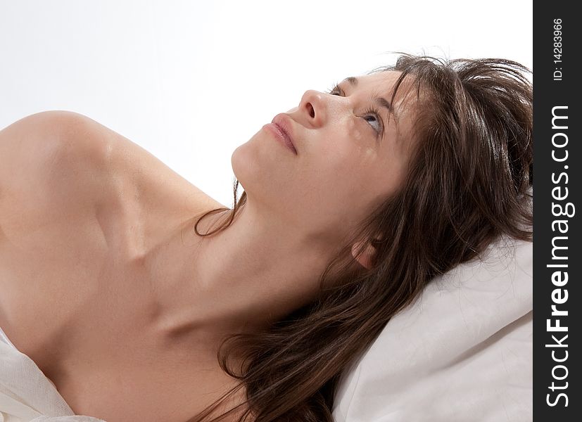 Young Woman Lying In Bed Looking Upward