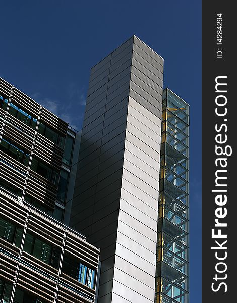 Top of a modern building in Paddington waterside area in London, England. Staircase with a yellow axis is seen through glass windows on the right side. Top of a modern building in Paddington waterside area in London, England. Staircase with a yellow axis is seen through glass windows on the right side.