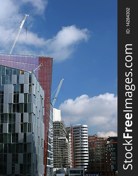Modern buildings along the Paddington bassin in London with cranes. Modern buildings along the Paddington bassin in London with cranes