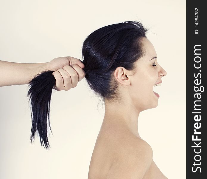 Girl yelling because her hair is pulled. Girl yelling because her hair is pulled