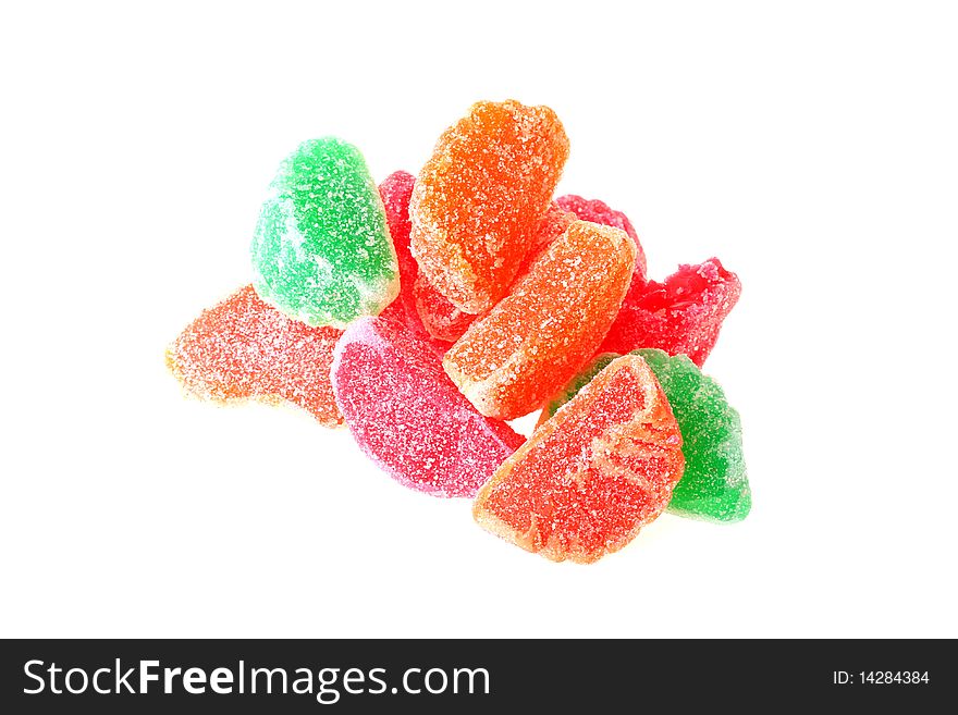 Fruit sweets of orange, green and red colour on a white background.