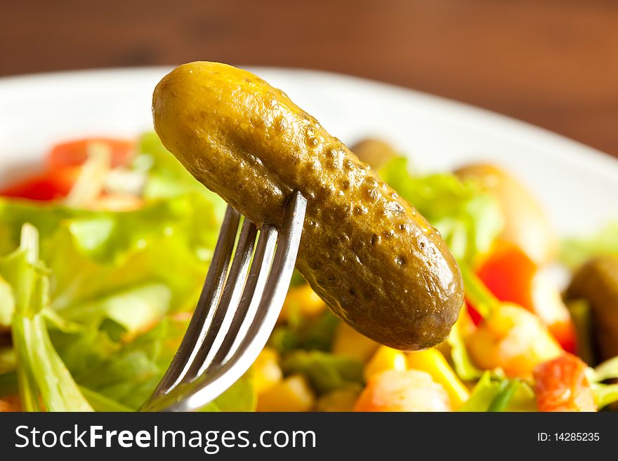 Photo of colorful salad in a table with cucumbers. Photo of colorful salad in a table with cucumbers