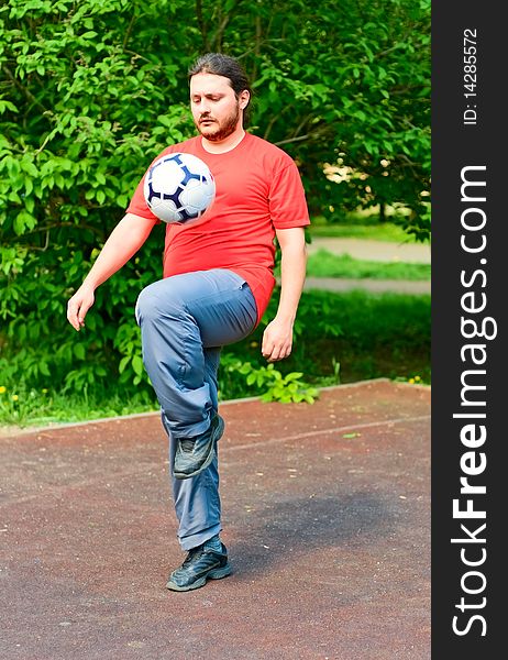 Young man playing soccer in park. Young man playing soccer in park
