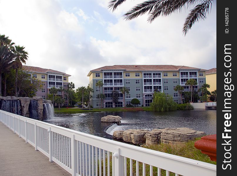 Waterfront condo living in tropical setting with palm trees, bridge and water. Waterfront condo living in tropical setting with palm trees, bridge and water