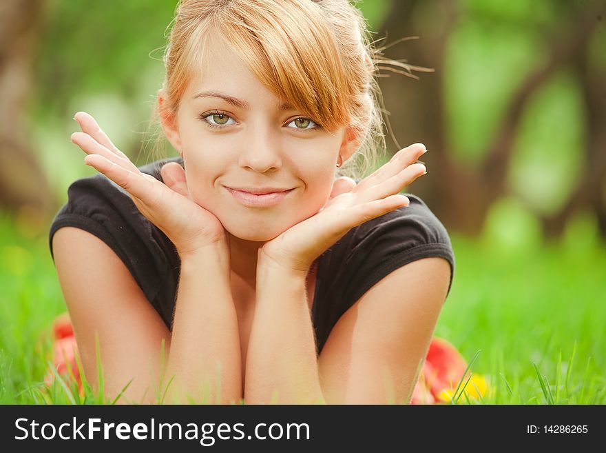 Young pretty girl lying on green grass. Young pretty girl lying on green grass