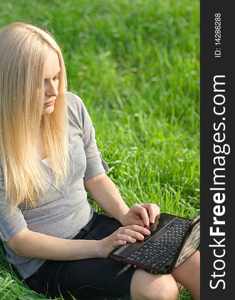 Series. The beautiful business woman with the laptop has a rest in the field