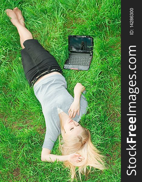 Series. The beautiful business woman with the laptop has a rest in the field