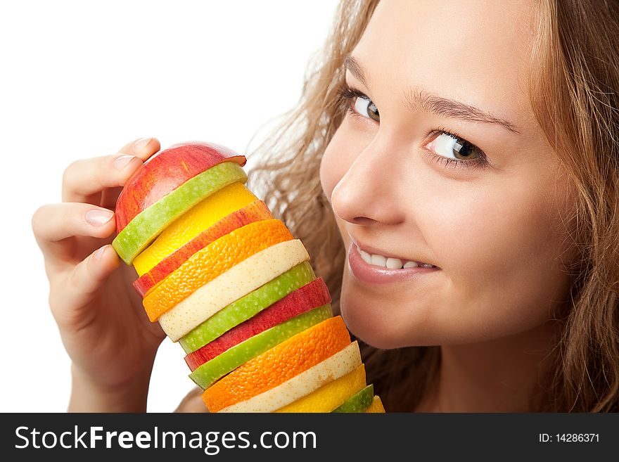 Portrait of happy young woman holding mixed fruits over white background