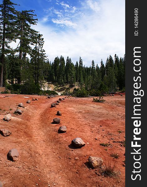 A rock lined path leading over the red dirt. A rock lined path leading over the red dirt