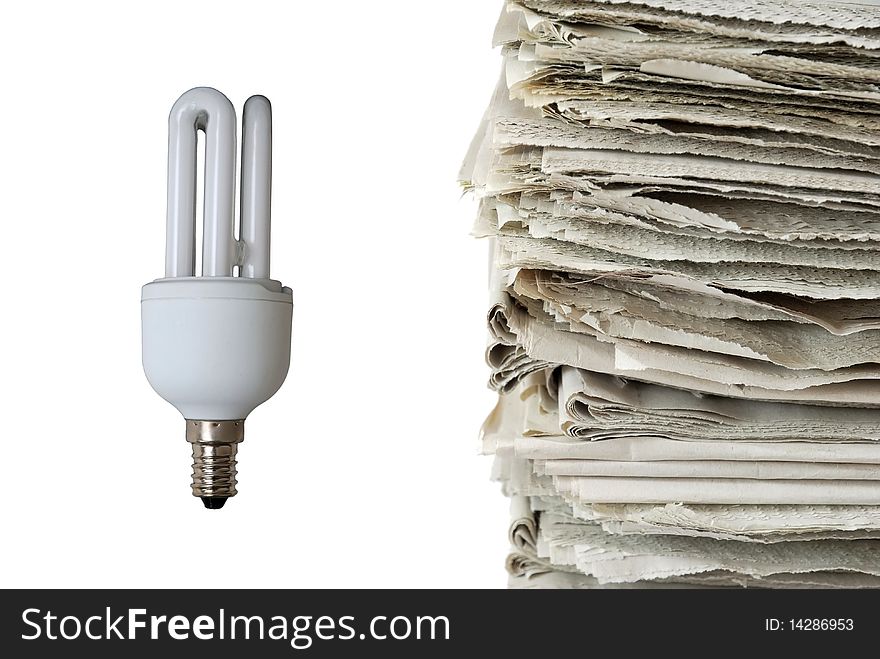 Light bulb and stack of old newspapers isolated on white background, signifying energy consumption, energy saving, renewable resources, and environmental conservation concepts. Light bulb and stack of old newspapers isolated on white background, signifying energy consumption, energy saving, renewable resources, and environmental conservation concepts.