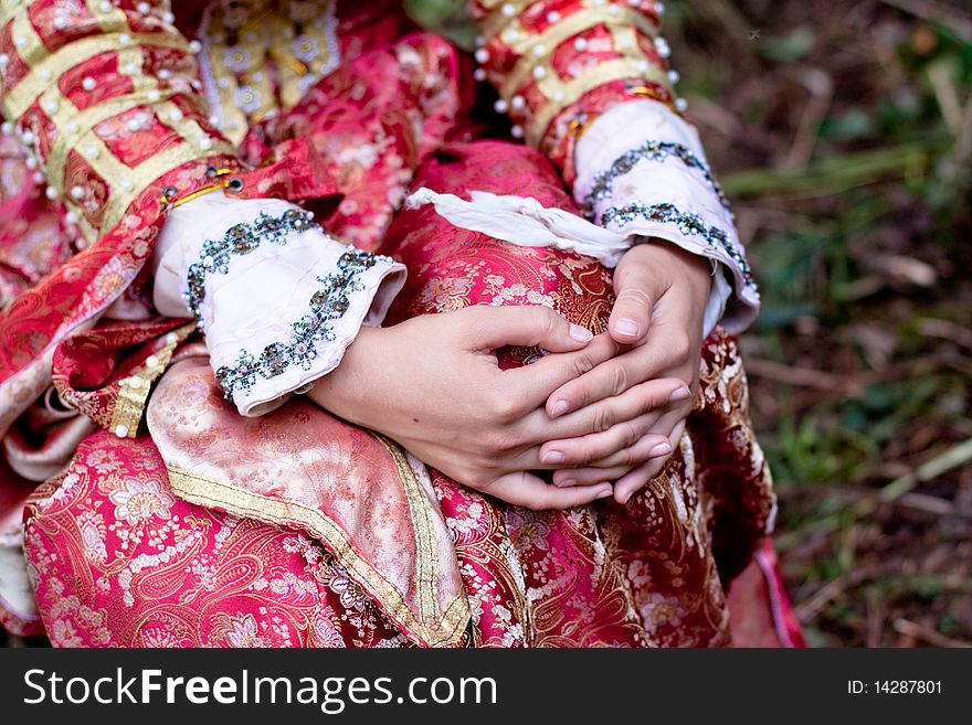 Girl hands and medieval red dress