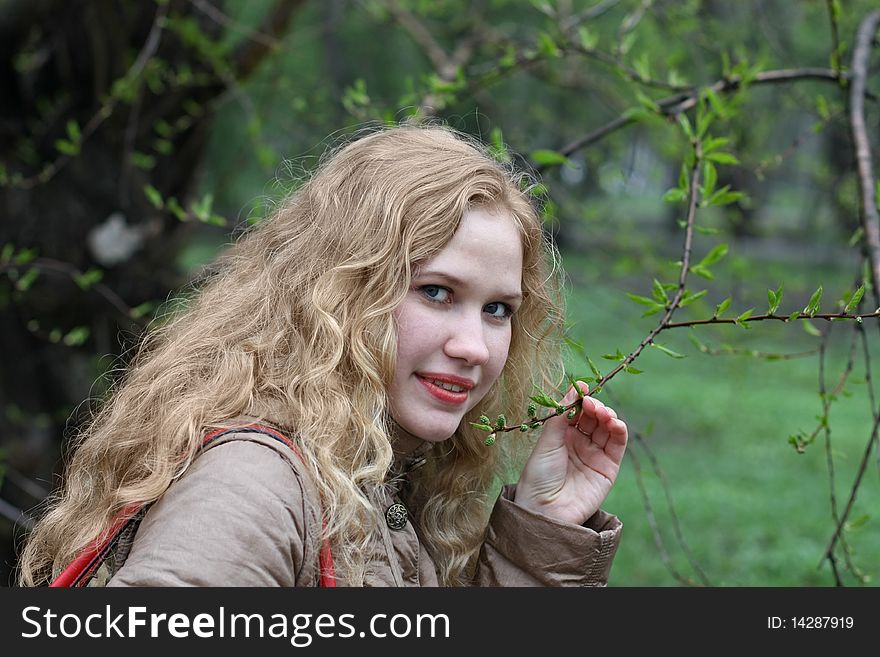 Girl and the branch with leaf buds