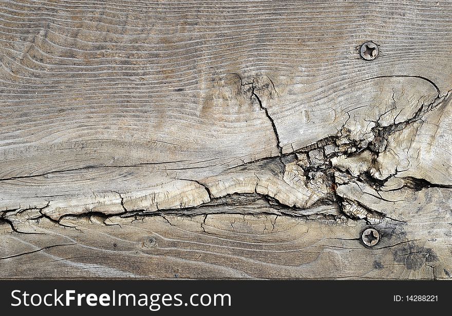 Closeup of cracked wood with two nails on the side. Closeup of cracked wood with two nails on the side.