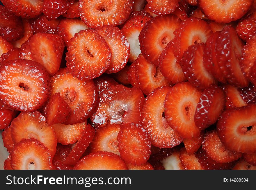 Closeup of lots of fresh shiny sliced and diced strawberries. Closeup of lots of fresh shiny sliced and diced strawberries