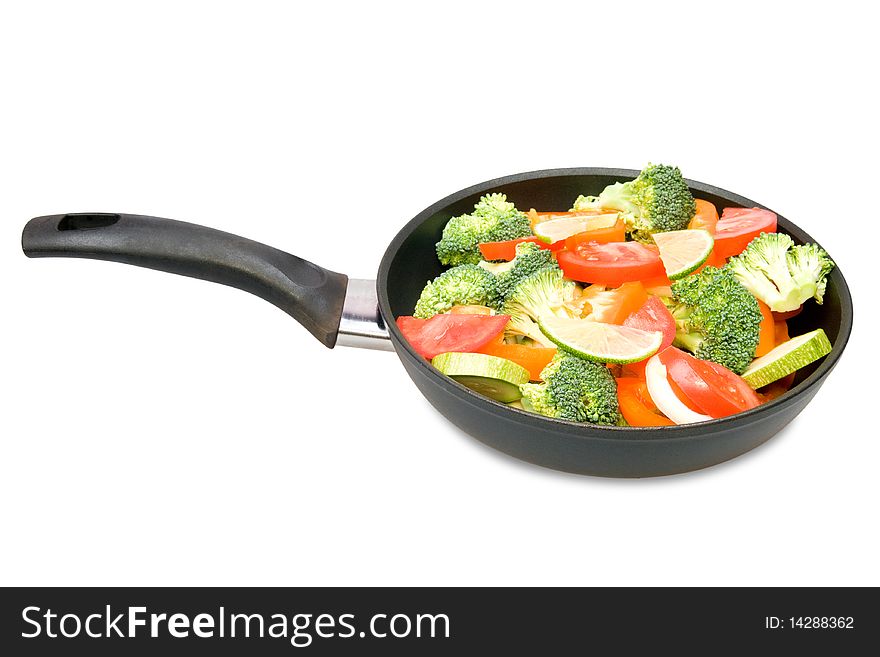 Red pepper, tomatoes, vegetable marrows and broccoli in a frying pan. Red pepper, tomatoes, vegetable marrows and broccoli in a frying pan