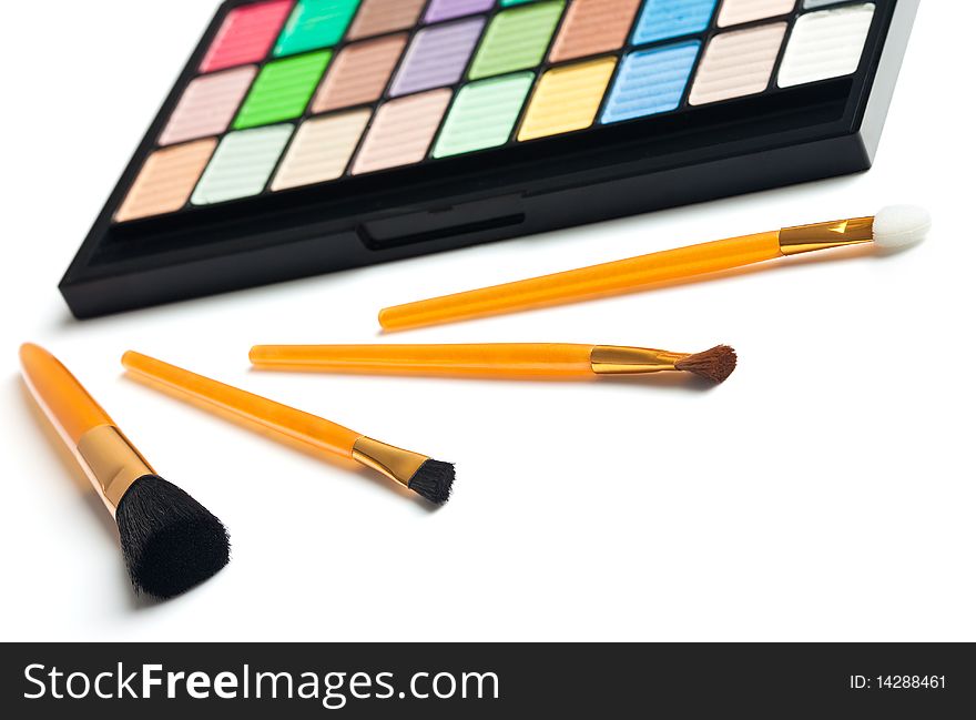 Cosmetic colorful palette and brush near