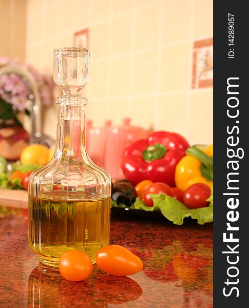 Fresh vegetables and olive oil on a kitchen table. Fresh vegetables and olive oil on a kitchen table