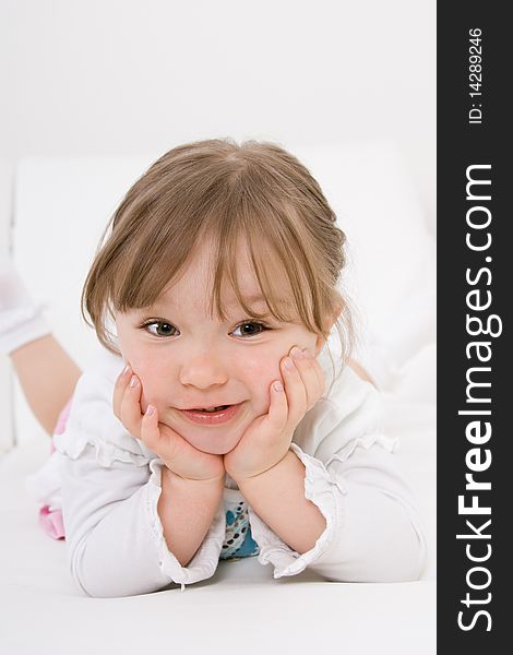 Sweet happy little girl on sofa