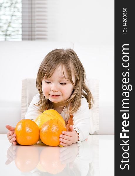 Sweet happy little girl with fruits