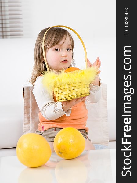 Sweet happy little girl with fruits