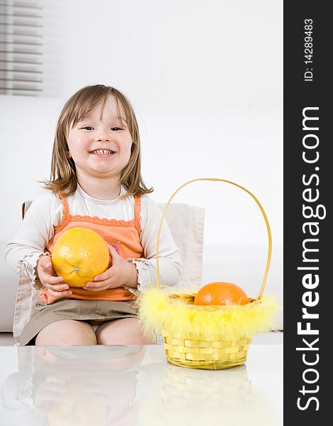 Sweet happy little girl with fruits