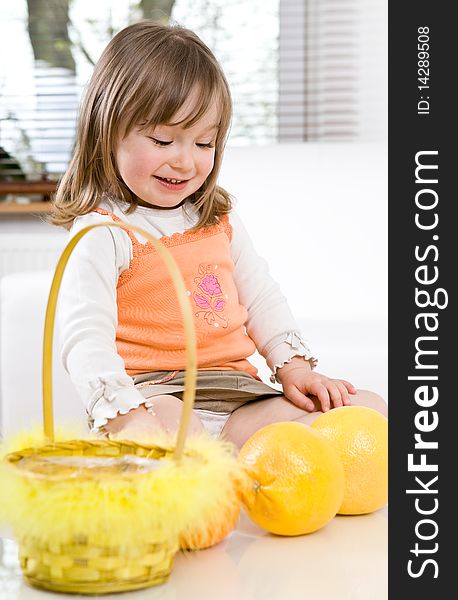 Sweet happy little girl with fruits