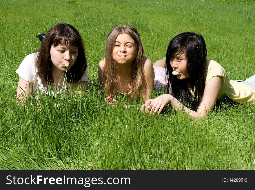 Three girls lying on grass