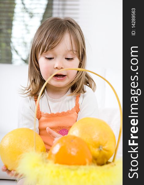 Sweet happy little girl with fruits