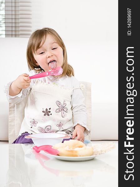 Sweet happy little girl eating