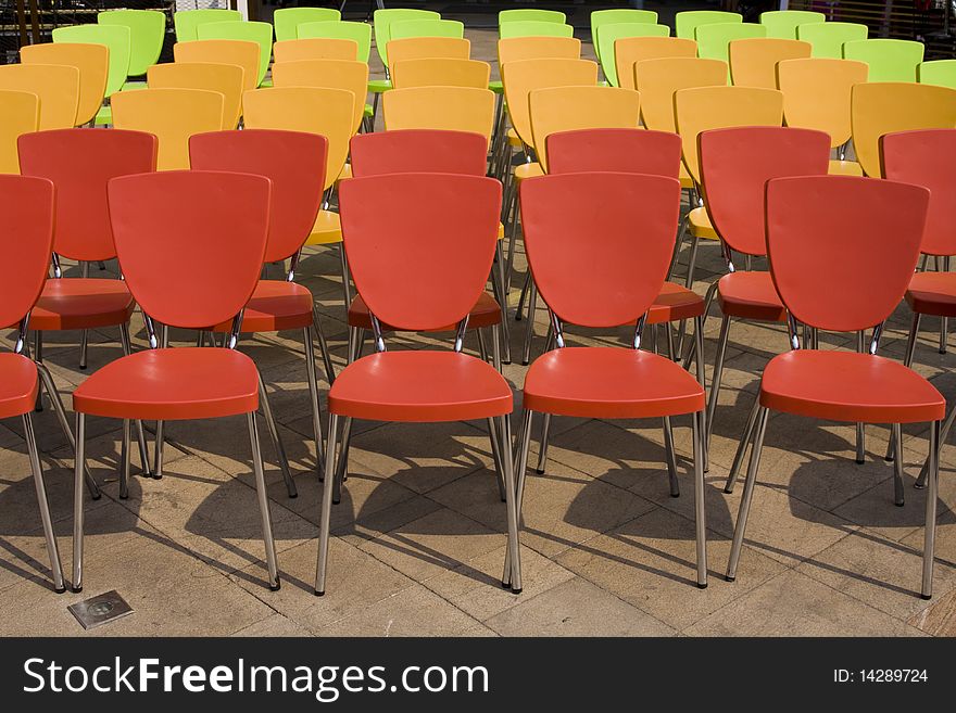 Colored chairs arranged in rows. Colored chairs arranged in rows