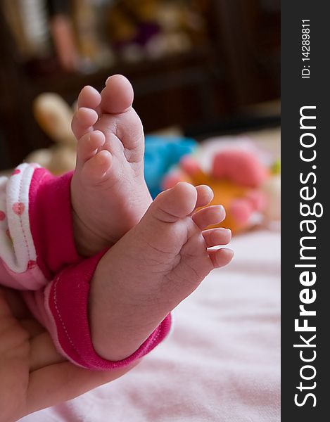 Baby girl feet in mother's hands