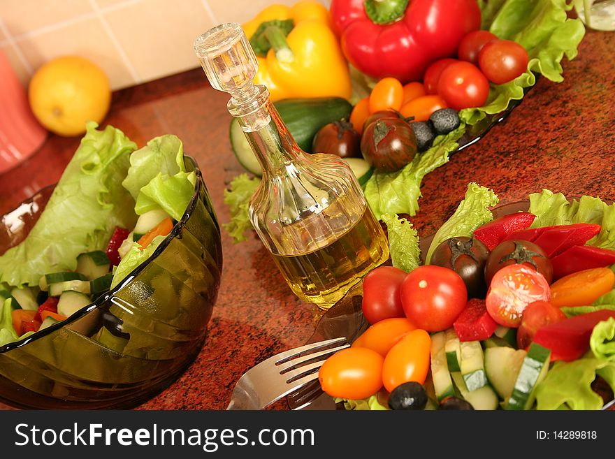 Fresh vegetables and olive oil on a kitchen table. Fresh vegetables and olive oil on a kitchen table