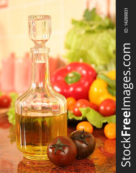 Fresh vegetables and olive oil on a kitchen table. Fresh vegetables and olive oil on a kitchen table