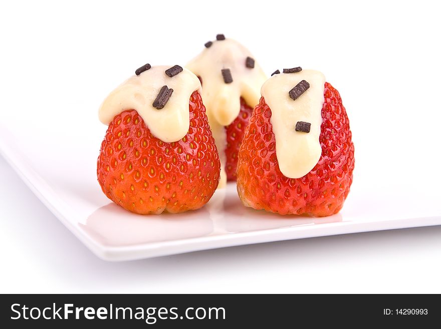 Strawberries with pudding on plate isolated