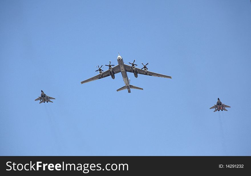 Strategic  Bomber Flies With Two Fighters