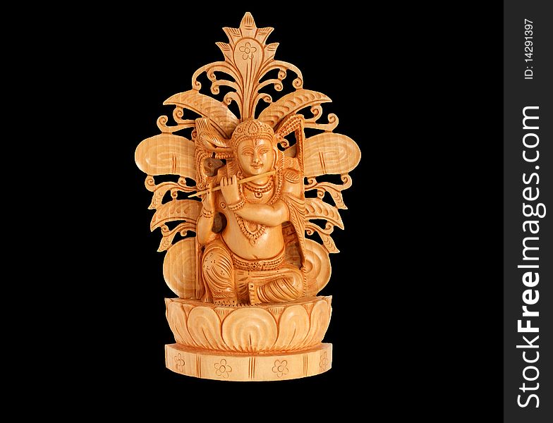 The wooden figure of God, a souvenir gift, India, in isolation. The wooden figure of God, a souvenir gift, India, in isolation