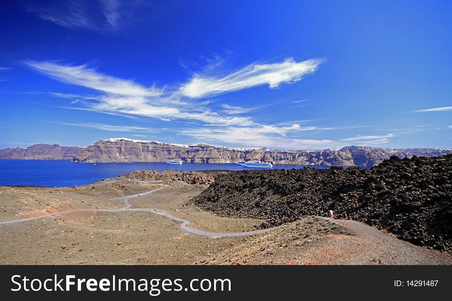 This is the caldera island Nea Kameni which is an active volcano just off the island of santorini, Greece. You can take guided tours of the island.