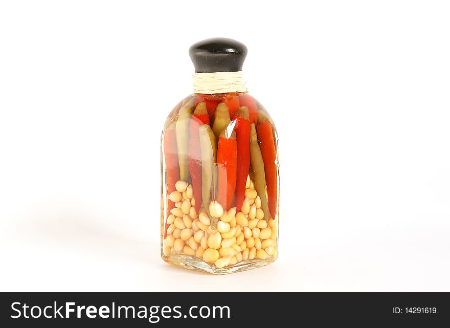 A glass jar of canned red pepper and corn, isolated on white